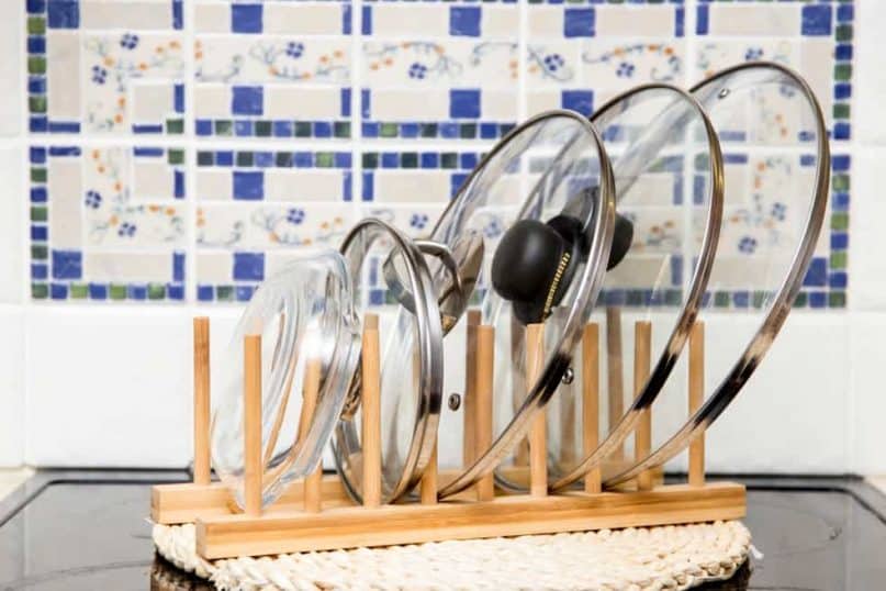 Use racks to store pot lids inside cabinets and drawers.