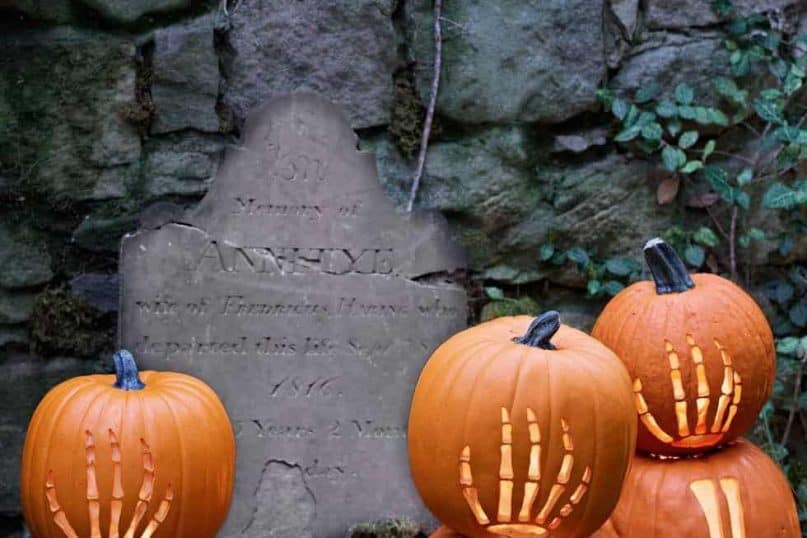 Carving pumpkins on gravestones