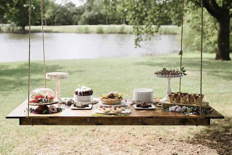 Tables suspended from the branches of trees